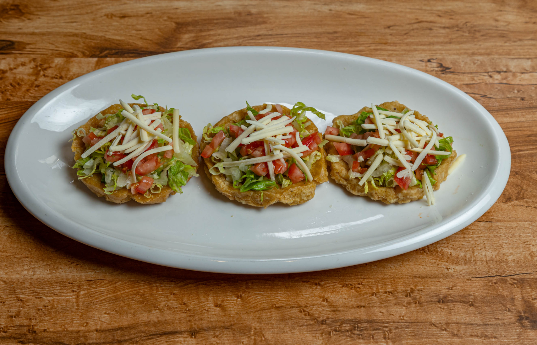 Three Mexican sopes with fresh toppings
